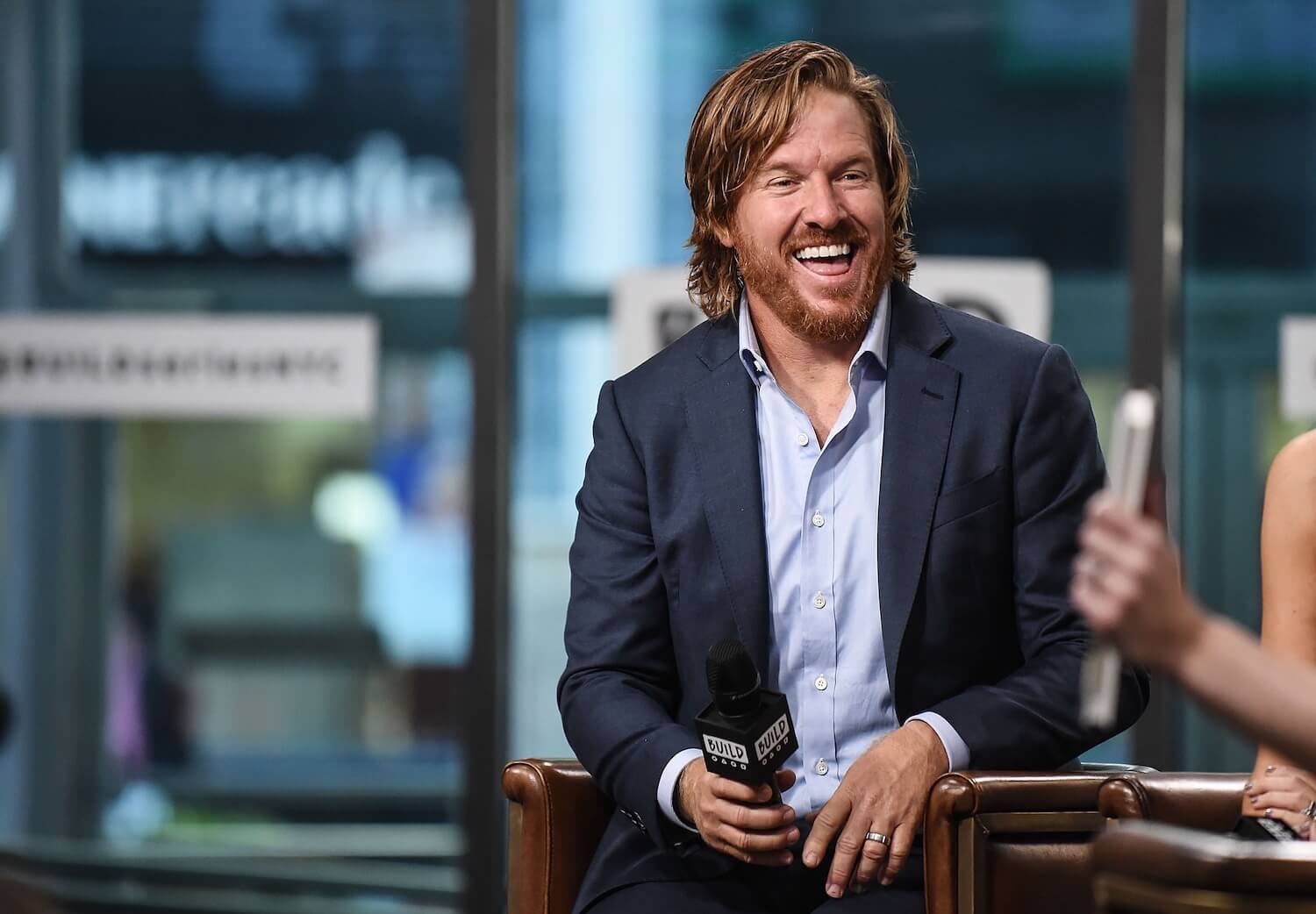Joanna Gaines' husband, Chip Gaines, from 'Fixer Upper' and the Magnolia brand, smiling during an interview