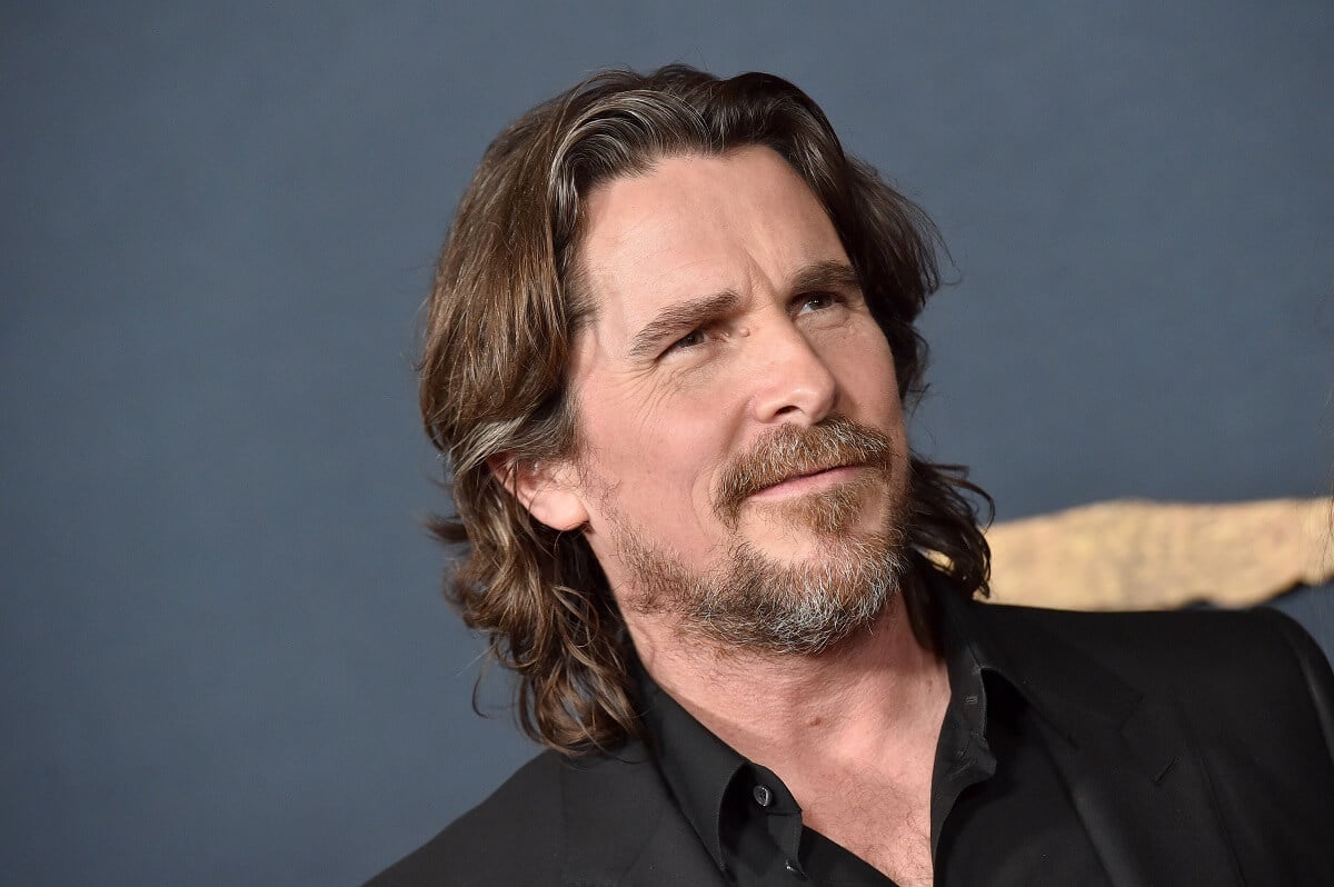 Christian Bale posing in a picture at 'The Pale Blue Eyes' premiere while wearing a black suit.