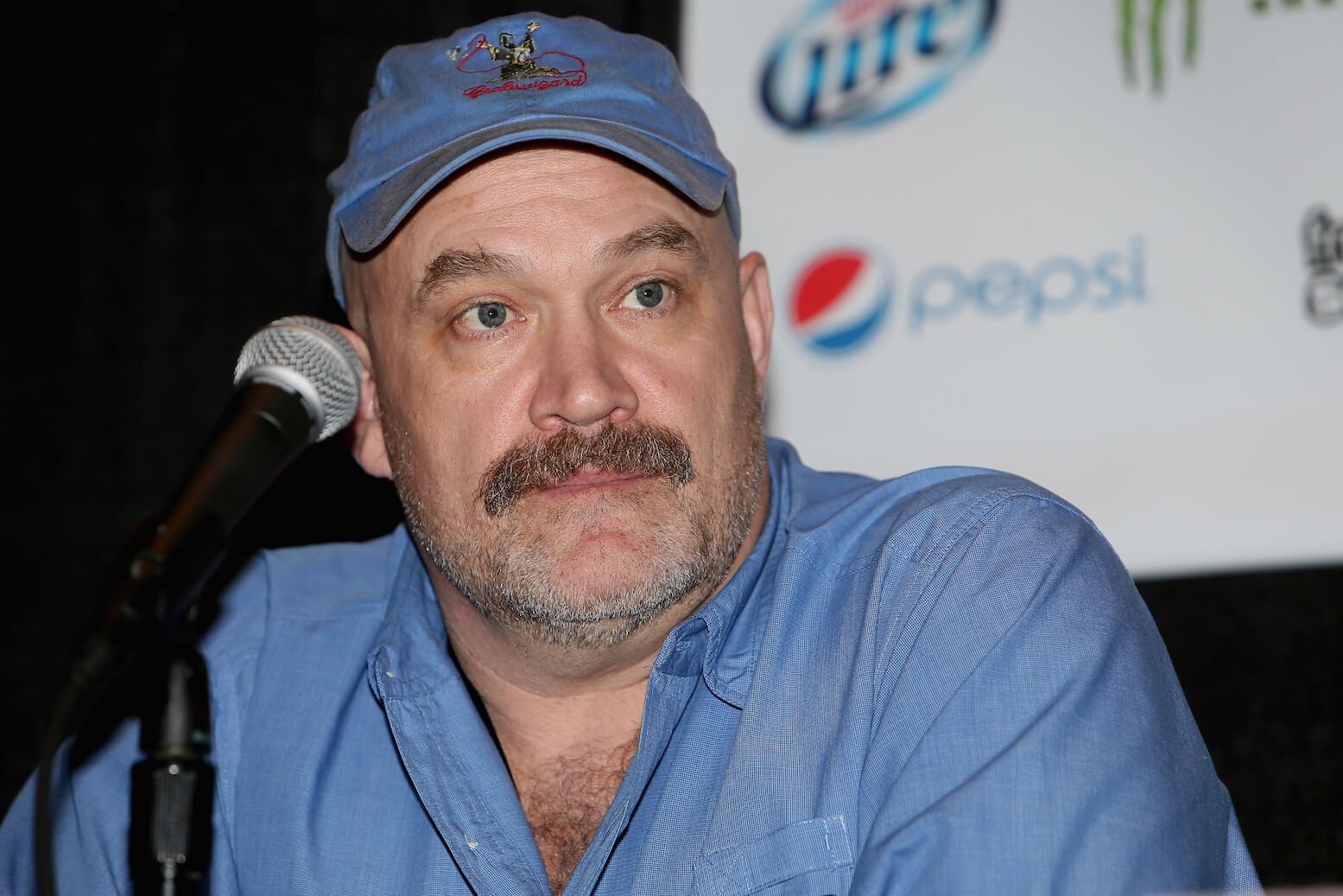 'Deadliest Catch' star Keith Colburn wearing a blue baseball cap and blue shirt at a conference