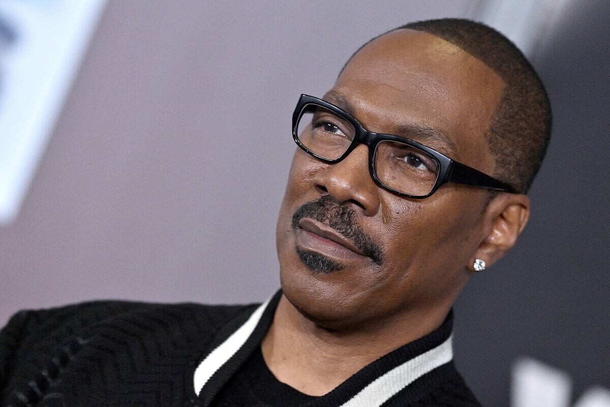 Eddie Murphy at the Los Angeles premiere of 'You People' wearing a jacket and glasses.