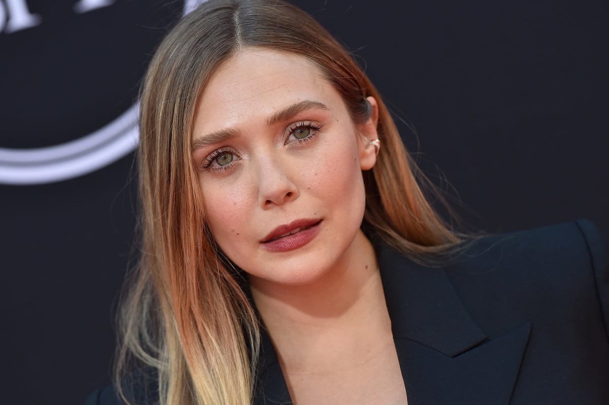 Elizabeth Olsen posing in a suit at the Espys.