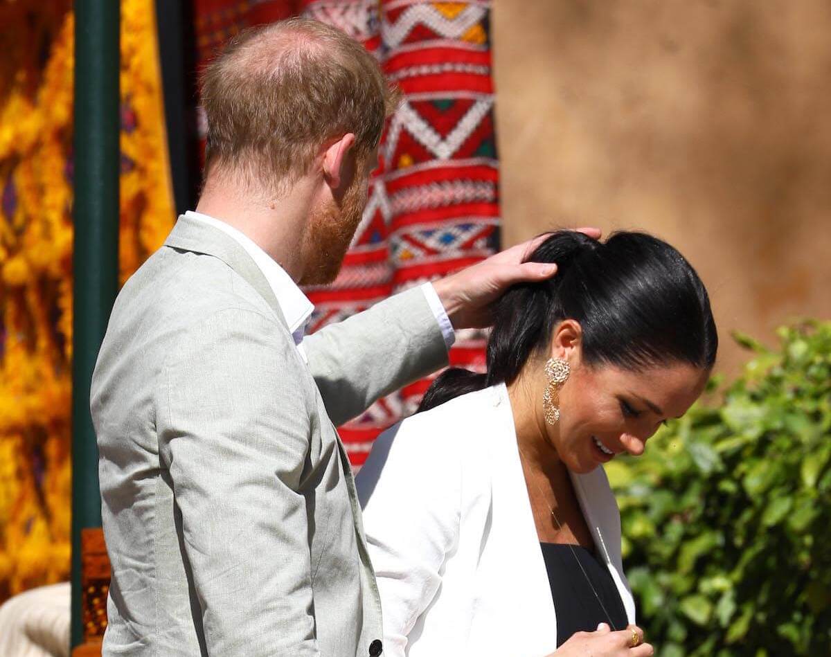 Prince Harry fixes Meghan's ponytail in 2019