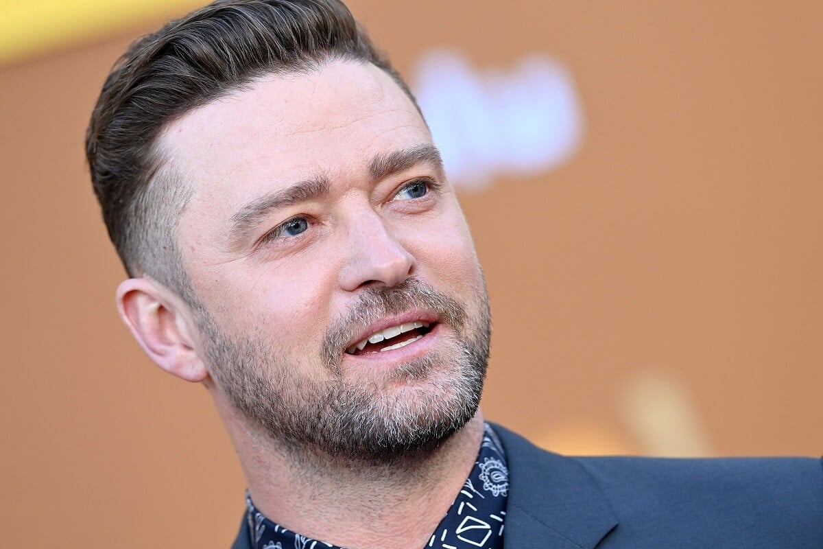 Justin Timberlake in a suit posing at the Los Angeles premiere for Hulu's 'Candy'.