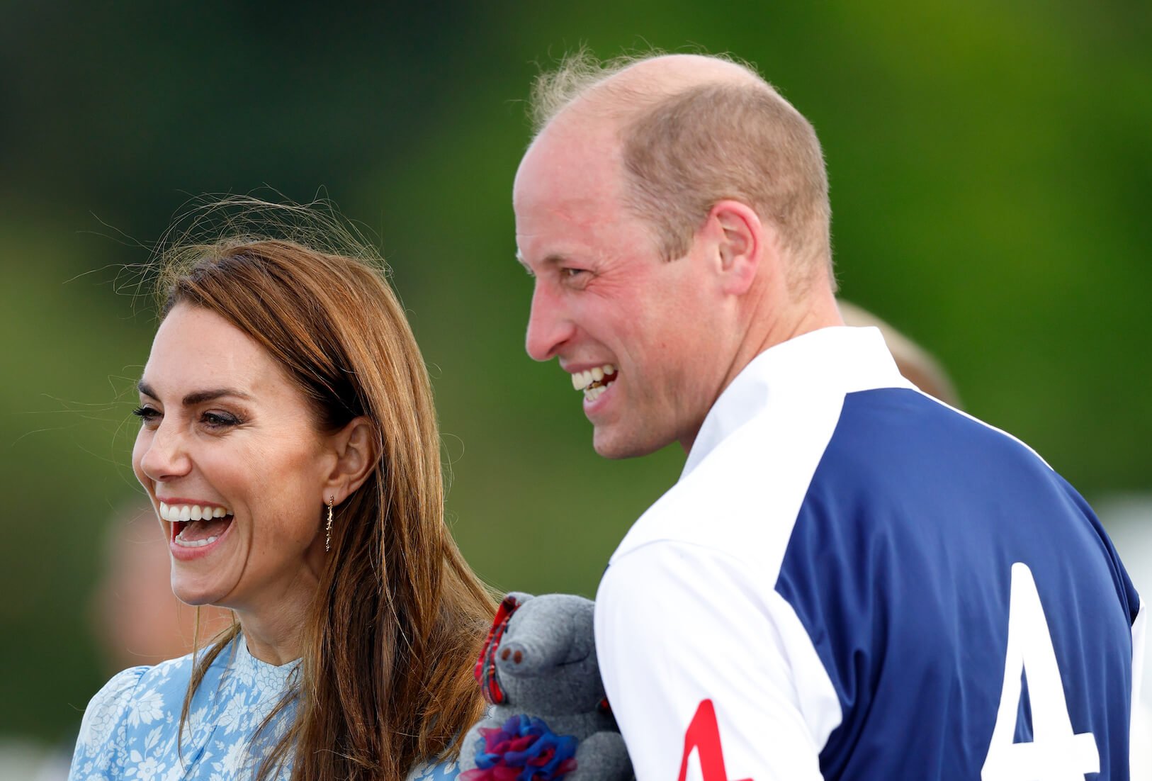 Kate Middleton and Prince William laughing at an outdoor event