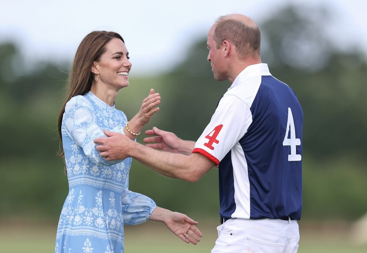 Kate Middleton and Prince William, who a body language expert says broke his rule to be closer to his wife, about to embrace after he took part in a Royal Charity Polo Cup 2023