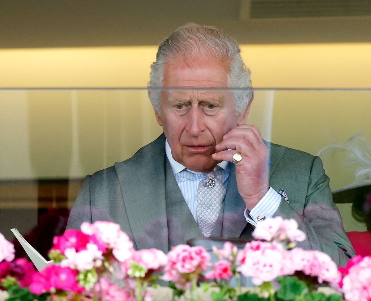 King Charles III watches his horse run in 'The Wolverton Stakes' on day one