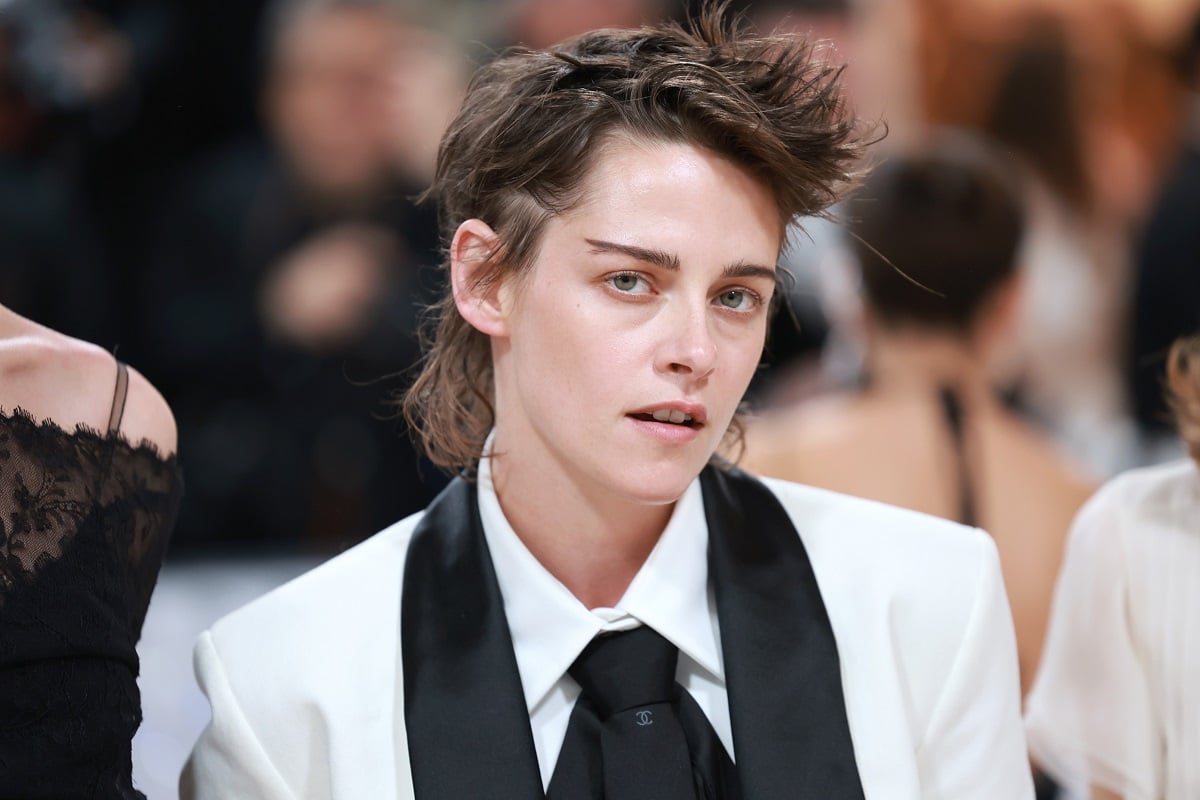 Kristen Stewart posing in a white jacket at the Met Gala.