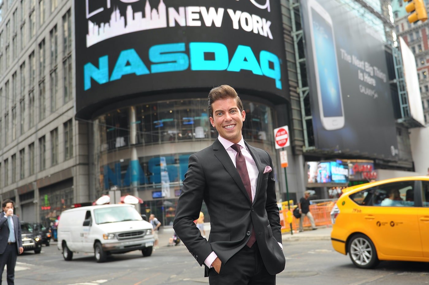 Luis D. Ortiz stands in the middle of NYC traffic with hands in pockets