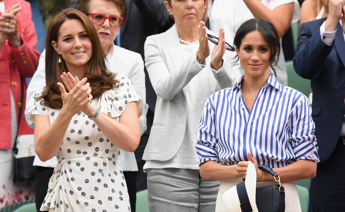 Meghan Markle and Kate Middleton, who a body language expert says showed signs of a rift during their forced outing at the Wimbledon 2018 Tennis Championship