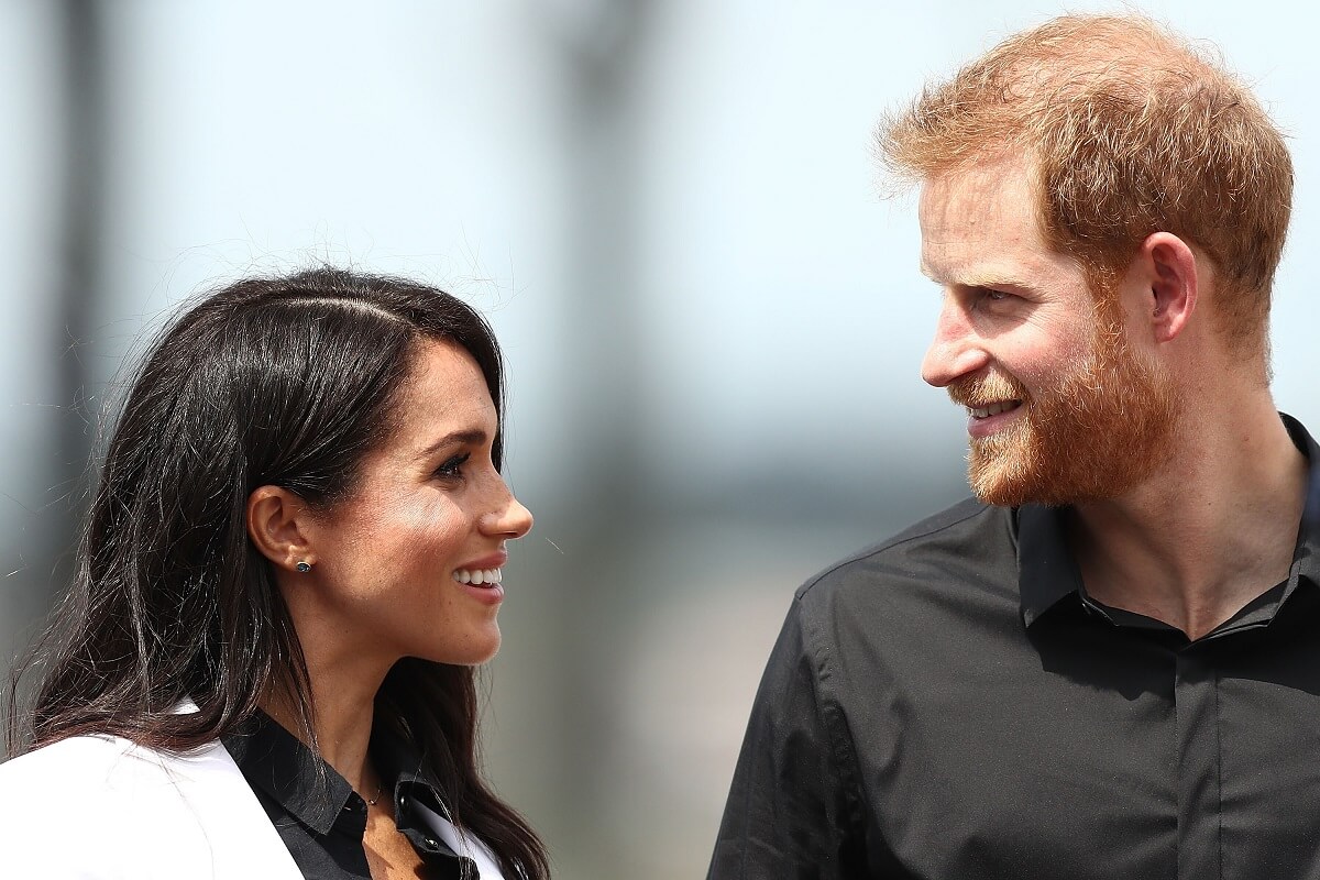 Meghan Markle and Prince Harry look at eachother during the JLR Drive Day at Cockatoo Island in Sydney, Australia