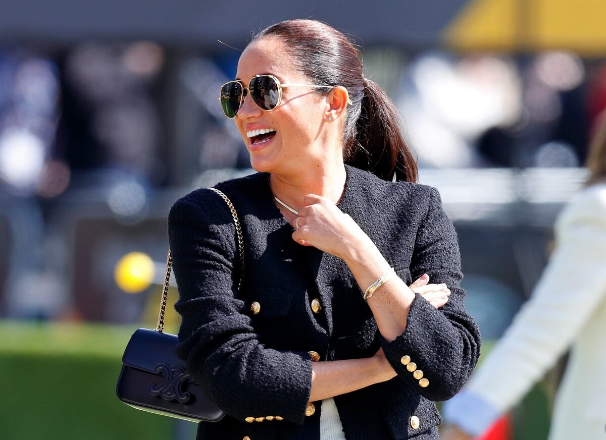 Meghan Markle, who has been seen 'living it up' while Prince Harry is away, attending Day 1 of the Invictus Games at Zuiderpark