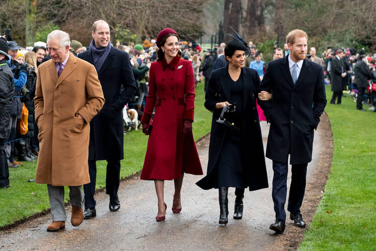 Meghan Markle, who reportedlly feels Prince William and Kate Middleton 'got away' with treating hre and Prince Harry badly, walks with the couple, her husband, and King Charles