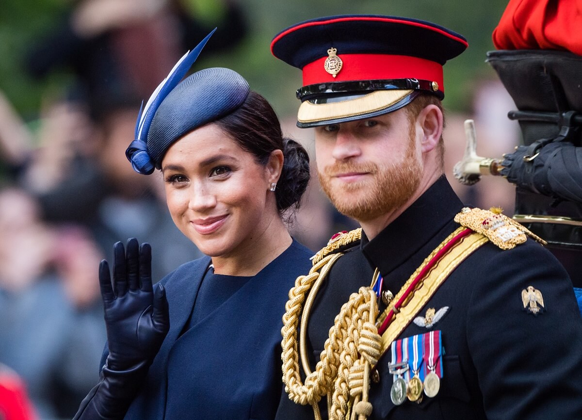 Meghan and Prince Harry ride by carriage down the Mall during Trooping The Colour in 2019