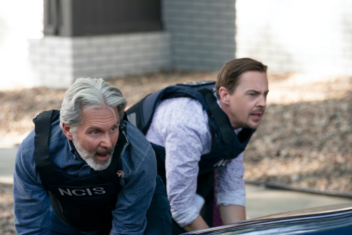 Parker and McGee crouched down and wearing bulletproof vests in the 'NCIS' Season 20 premiere