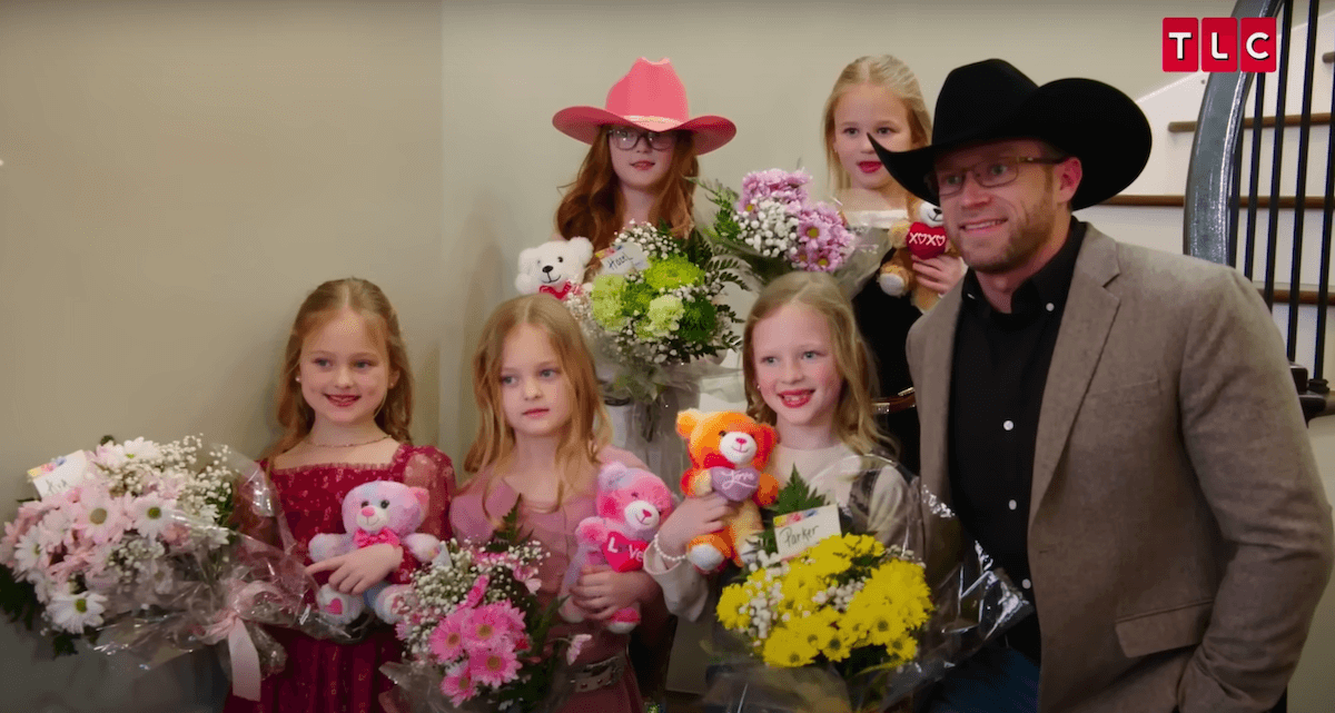 Adam Busby, wearing a cowboy hat, poses with his daughters before a father-daughter dance in 'OutDaughtered' Season 9
