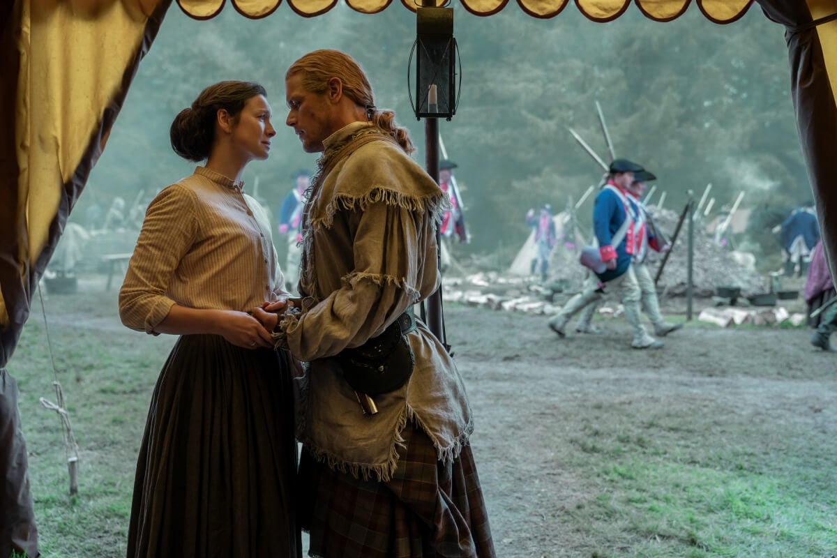 Outlander stars Caitriona Balfe and Sam Heughan in an image from season 7