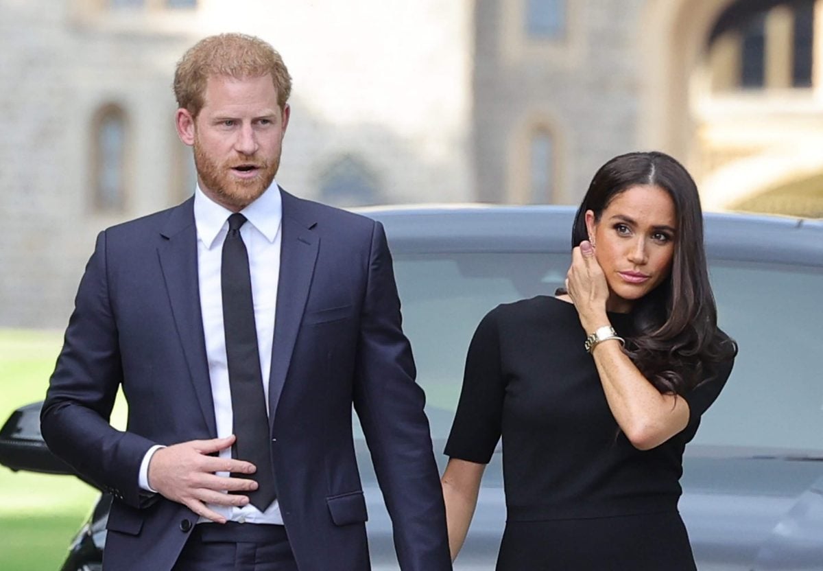 Prince Harry and Meghan Markle, who an expert says we're witnessing the 'beginning of the end' of their Hollywood ambitions, walking to meet members of the public at Windsor Castle following Queen Elizabeth II's death