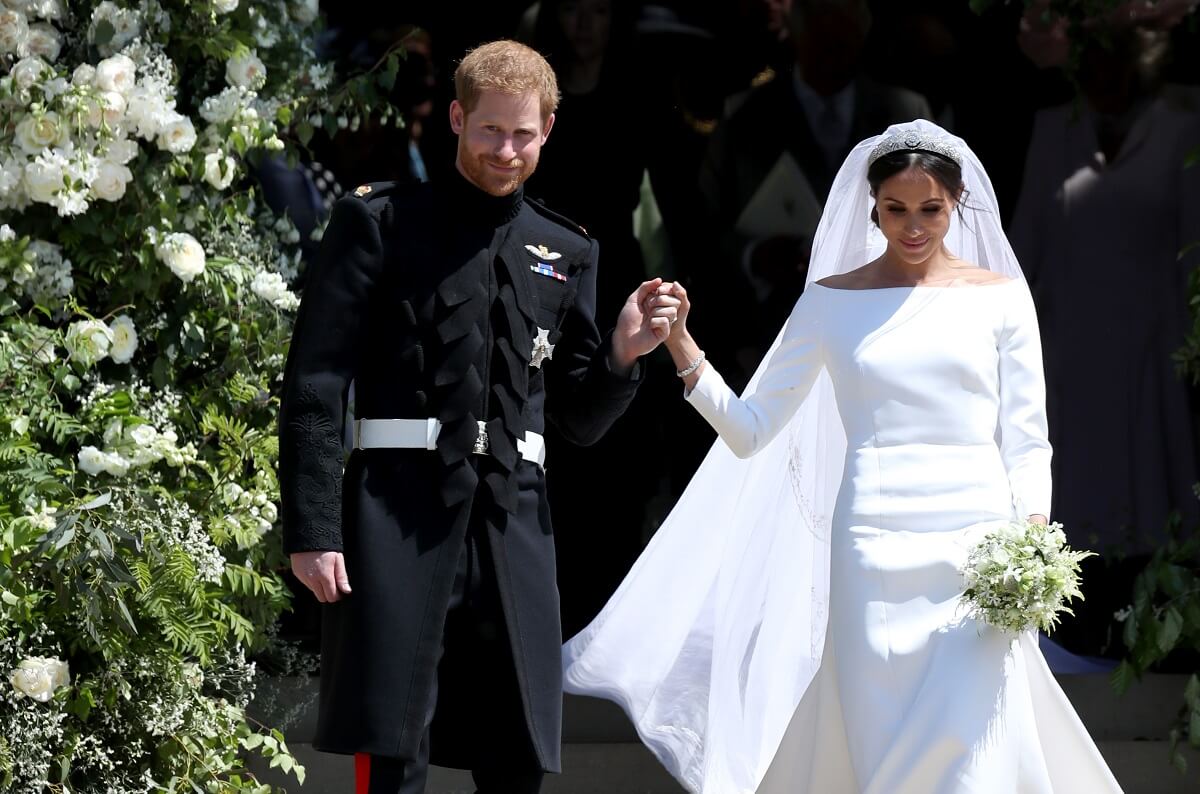 Prince Harry, who a body language expert is pointing out showed signs there would be changes in his attitude after wedding, leaving St George's Chapel with Meghan Markle