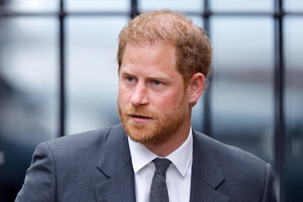 Prince Harry, whose 'Royal Highness' title the royal family removed from their website, looks on