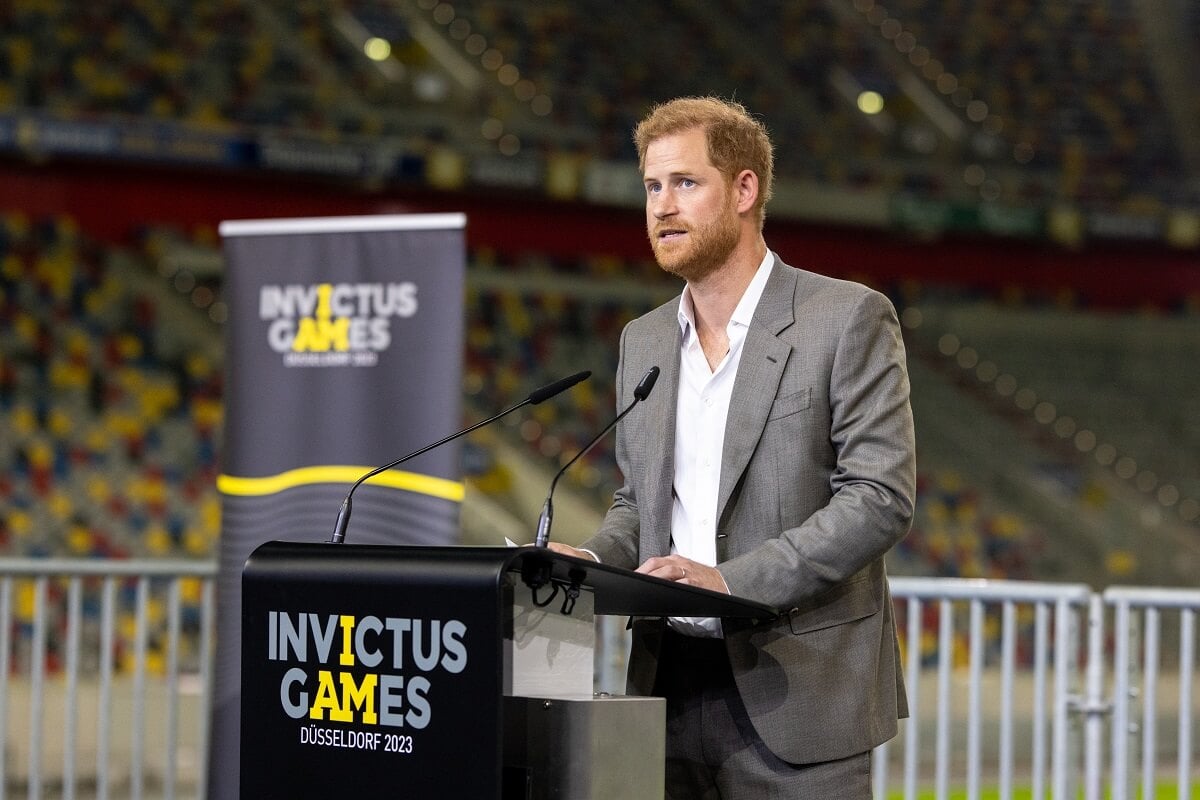 Prince Harry, whose body language in 'Heart of Invictus' trailer was analyzed, speaks on stage during the press conference at the Invictus Games Dusseldorf 2023 - 'One Year To Go' events