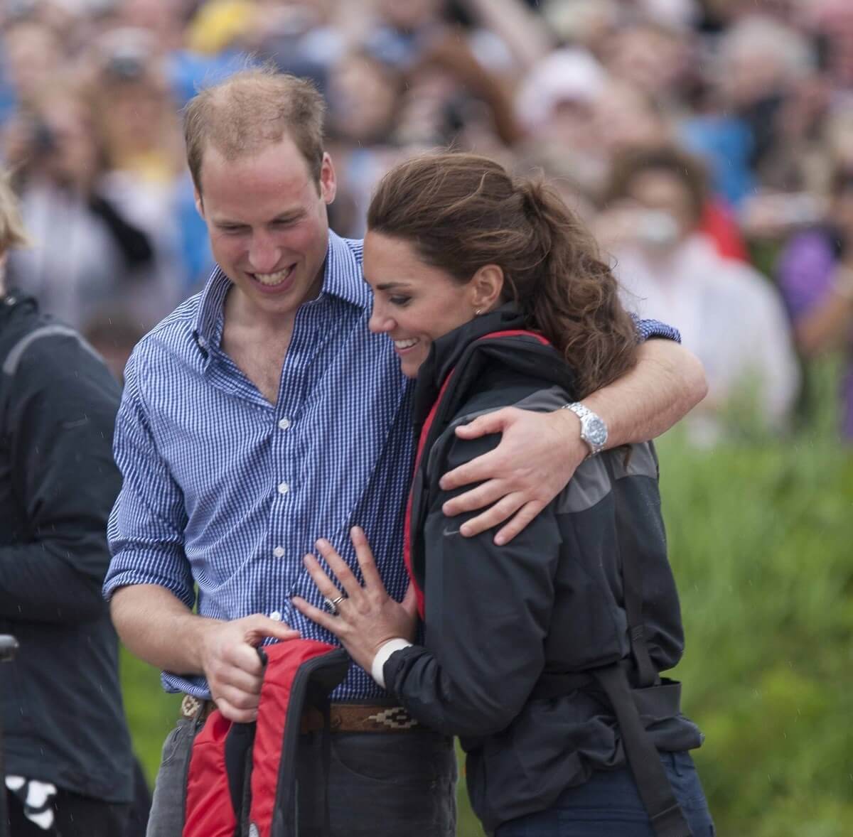 Prince William and Kate Middleton hug after taking part in a dragon boat race
