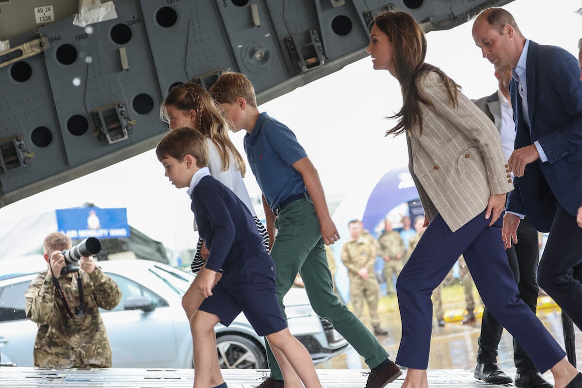 Prince William and Kate Middleton, who may be under 'pressure' for taking long vacations with Prince George, Princess Charlotte, and Prince Louis, walk with their three children