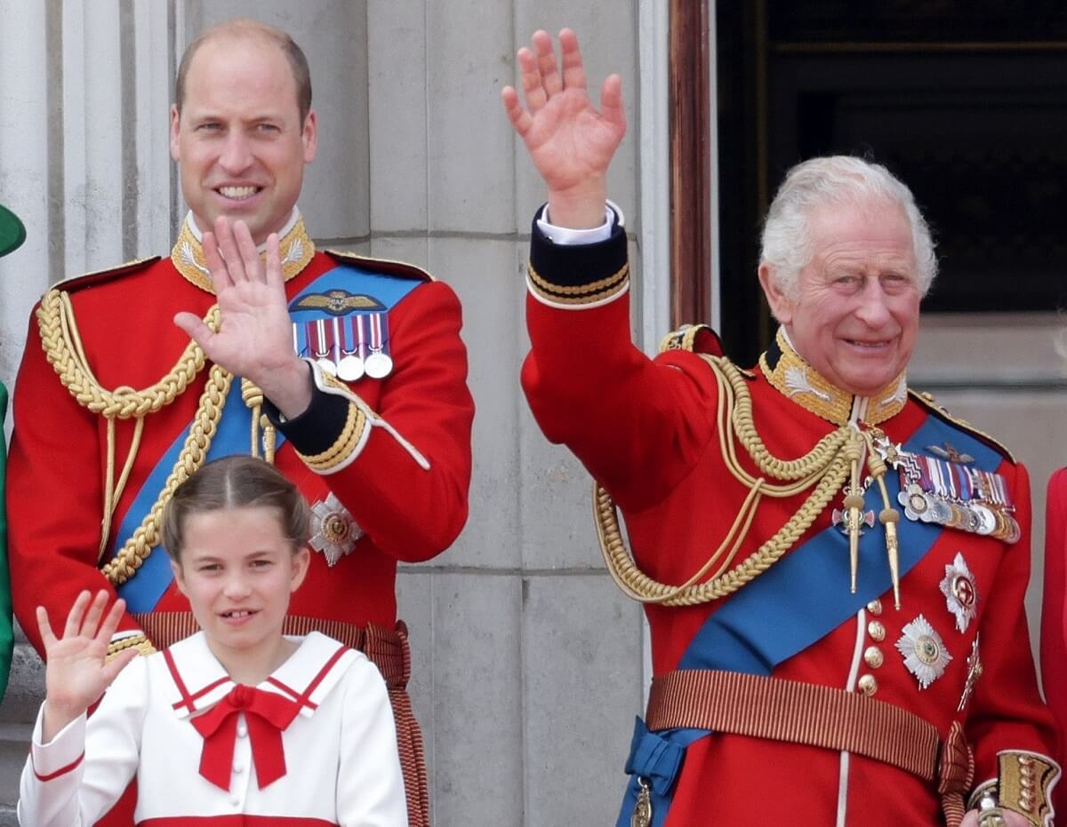 Prince William and King Charles III, who was seen on video joking a sharing a 'grandpa' moment with Princess Charlotte, standing on the balcony of Buckingham Palace during Trooping the Colour