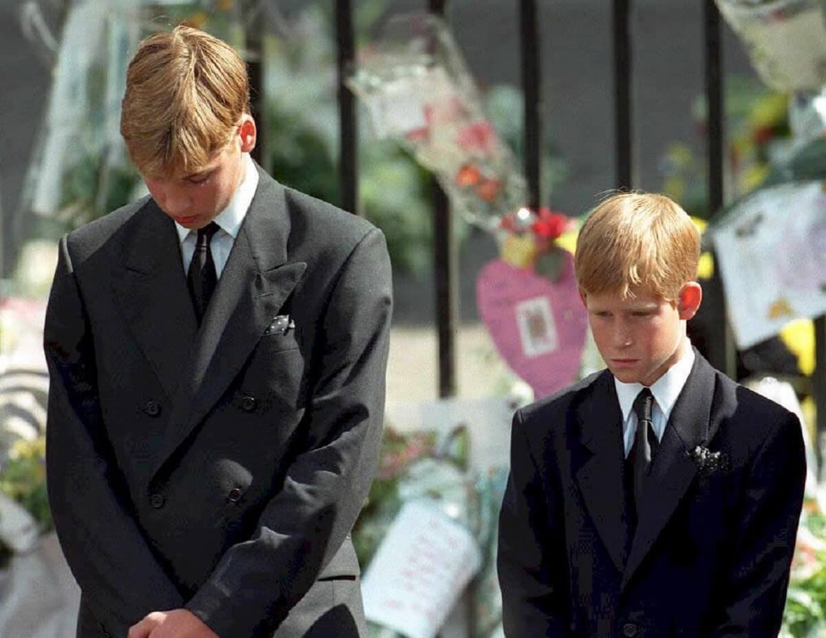 Prince William and Prince Harry bow their heads as their mother's coffin is taken out of Westminster Abbey