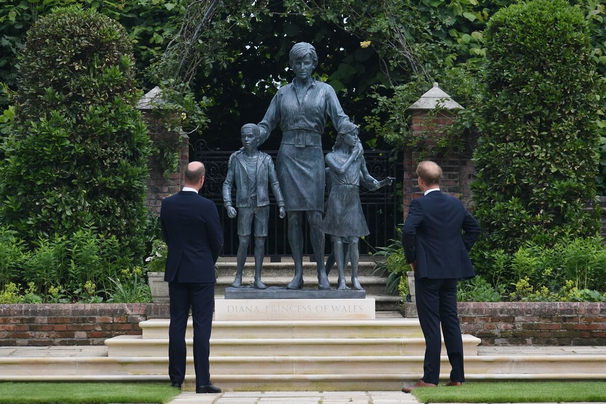 Prince William and Prince Harry look at a statue they commissioned of their mother Princess Diana in the Sunken Garden at Kensington Palace