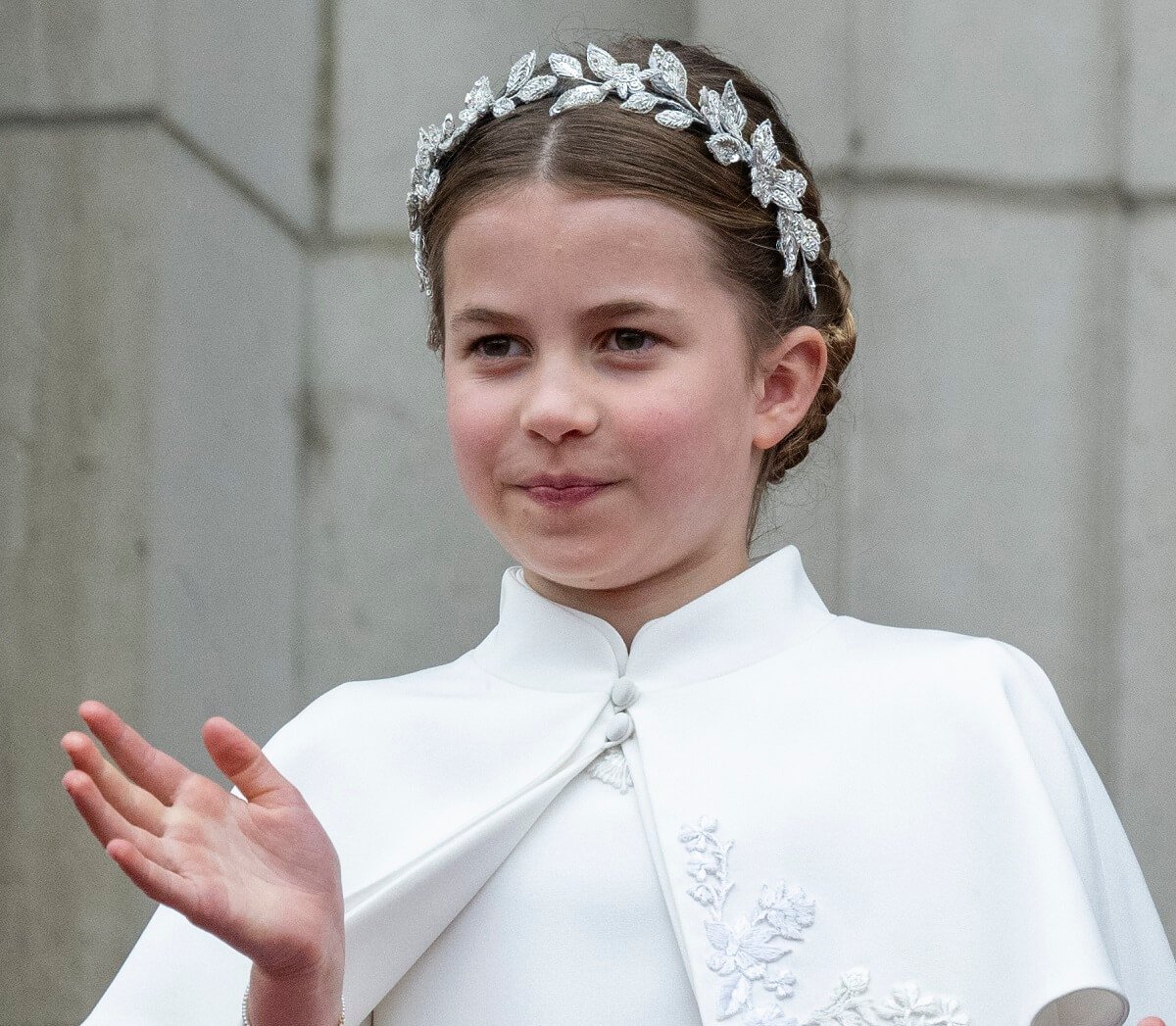 Princess Charlotte standing on the balcony of Buckingham Palace during the coronation of King Charles III