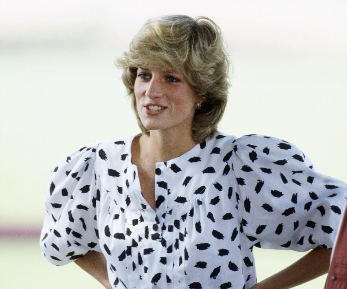 Princess Diana, who a body language expert says Princess Beatrice has some of the same traits, watching a polo match in Cirencester