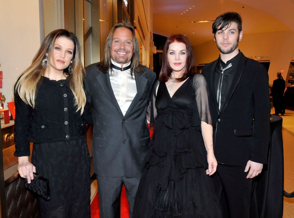 Lisa Marie Presley, Vince Neil, Priscilla Presley, and Navarone Garibaldi Garcia wear black and stand facing the camera.