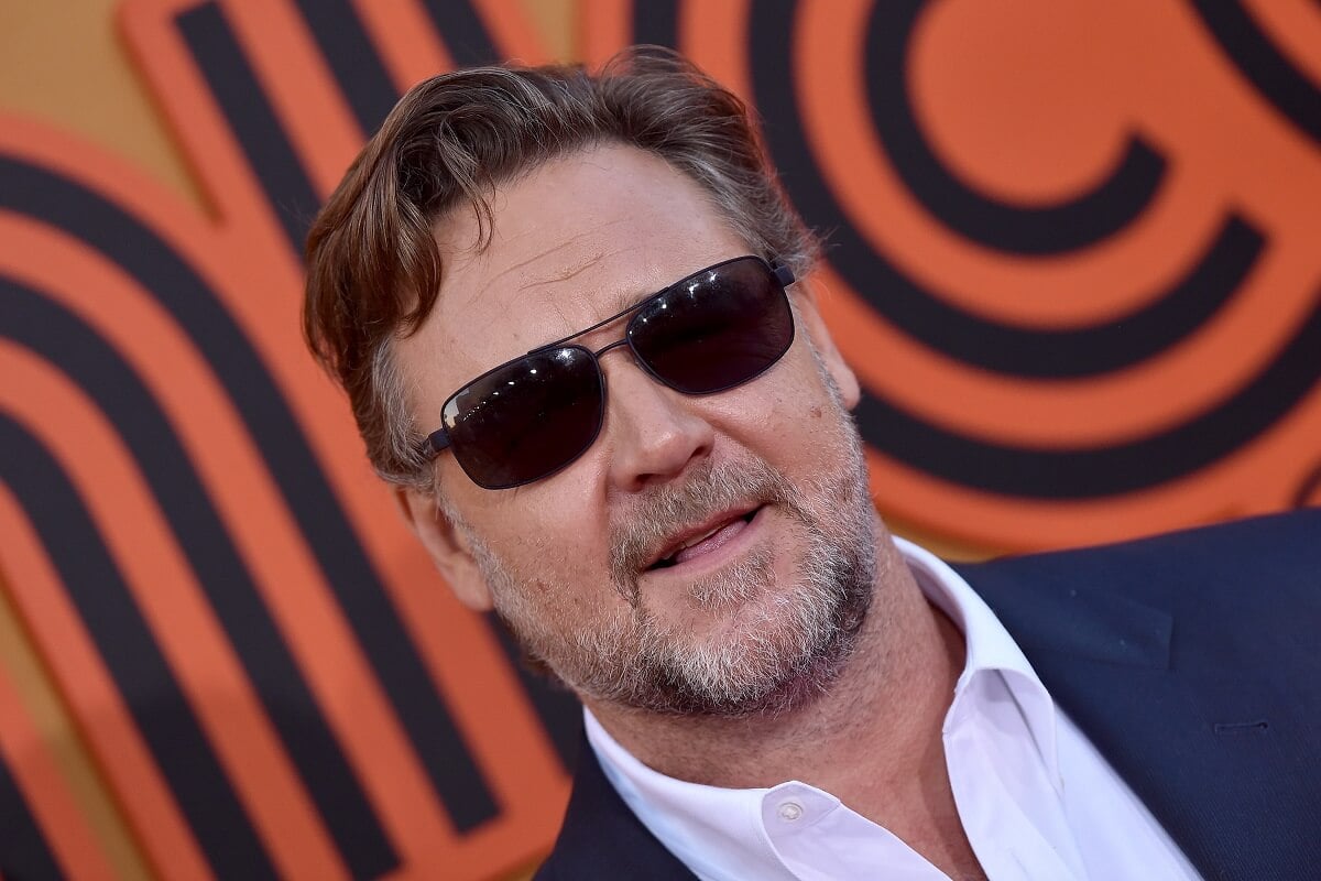 Russell Crowe posing while wearing a suit and shades at the premiere of Warner Bros. Pictures' 'The Nice '.