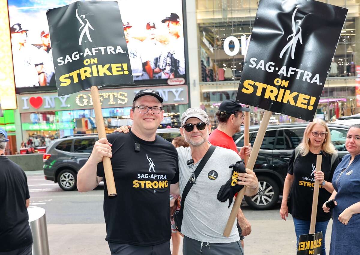 Duncan Crabtree-Ireland and Christian Slater are seen in Manhattan during the SAG-AFTRA strike