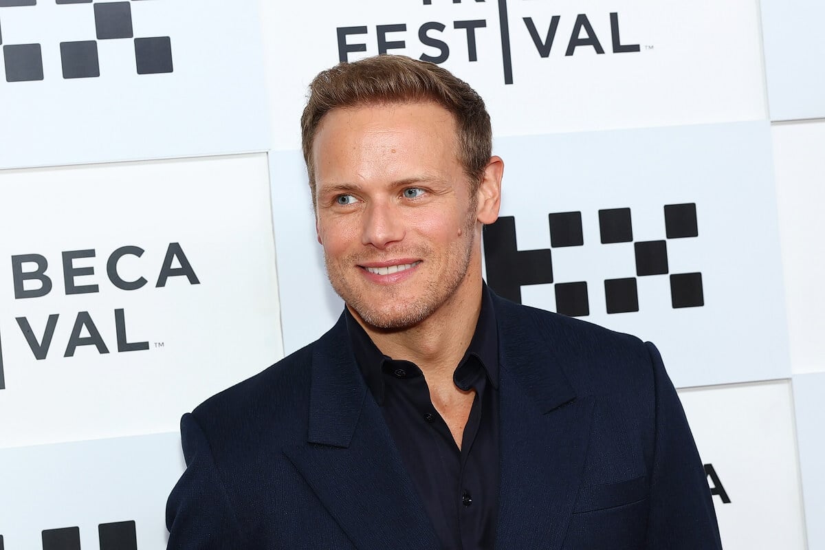 Sam Heughan posing in a suit at the the "Outlander" premiere during the 2023 Tribeca Festival.