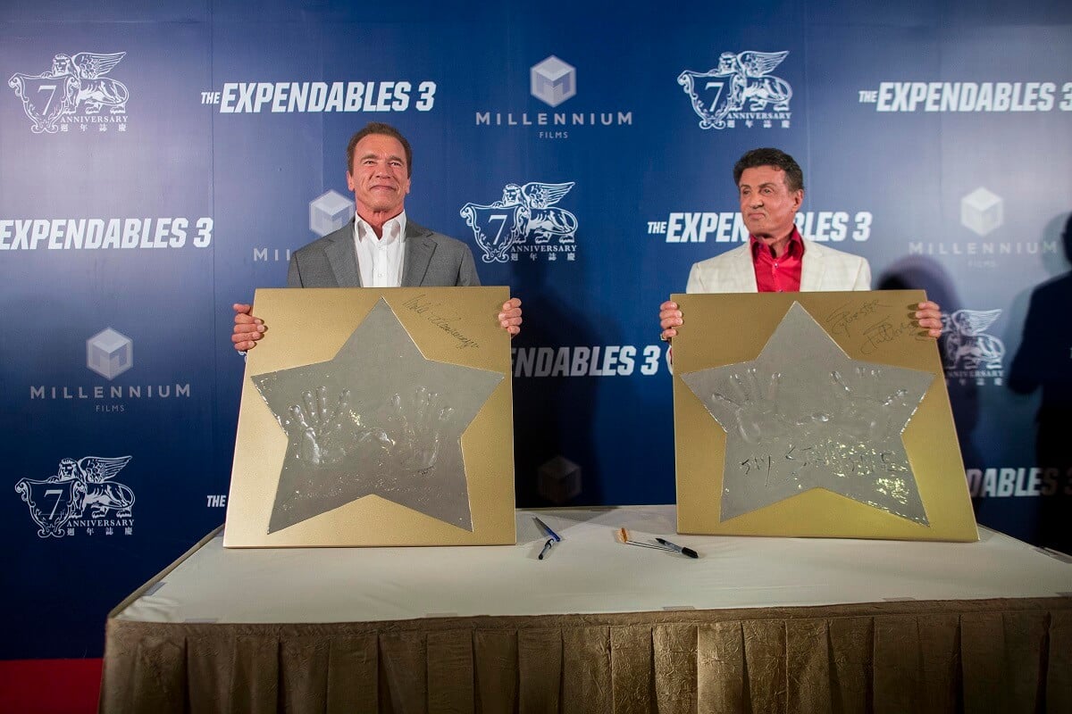 Sylvester Stallone and Arnold Schwarzenegger showing off their hand prints show off their hand prints during a photocall at a special screening of 'The Expendables 3'