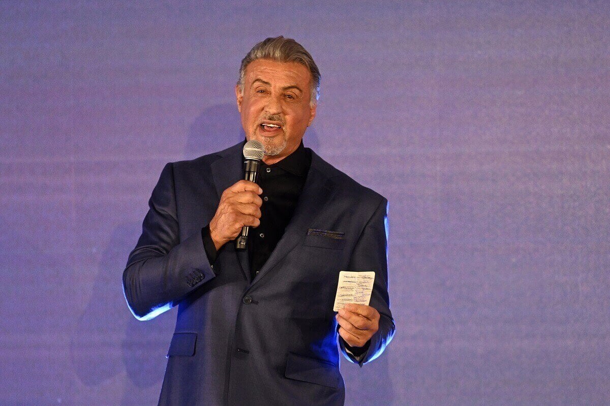 Sylvester Stallone on stage speaking in a suit onstage during the Paramount+ UK launch.