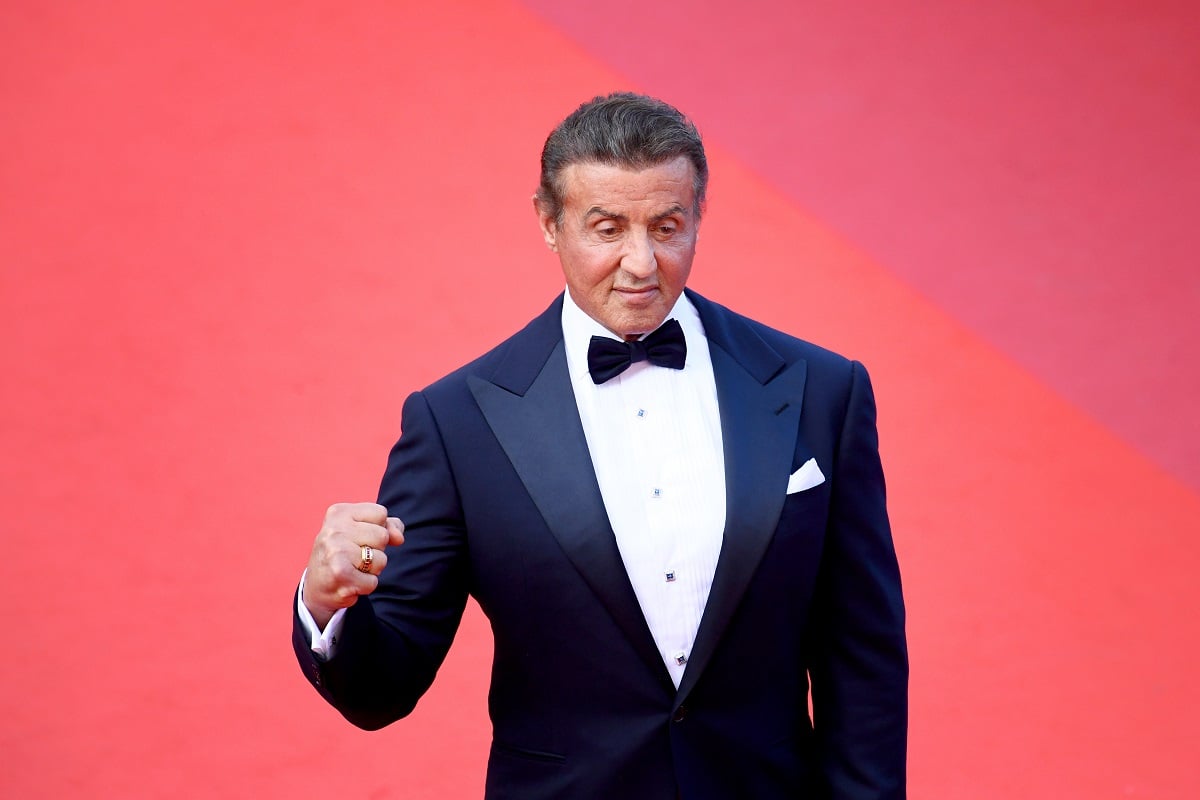 Sylvester Stallone posing in a suit at a screening of 'The Specials' at Cannes Film Festival.