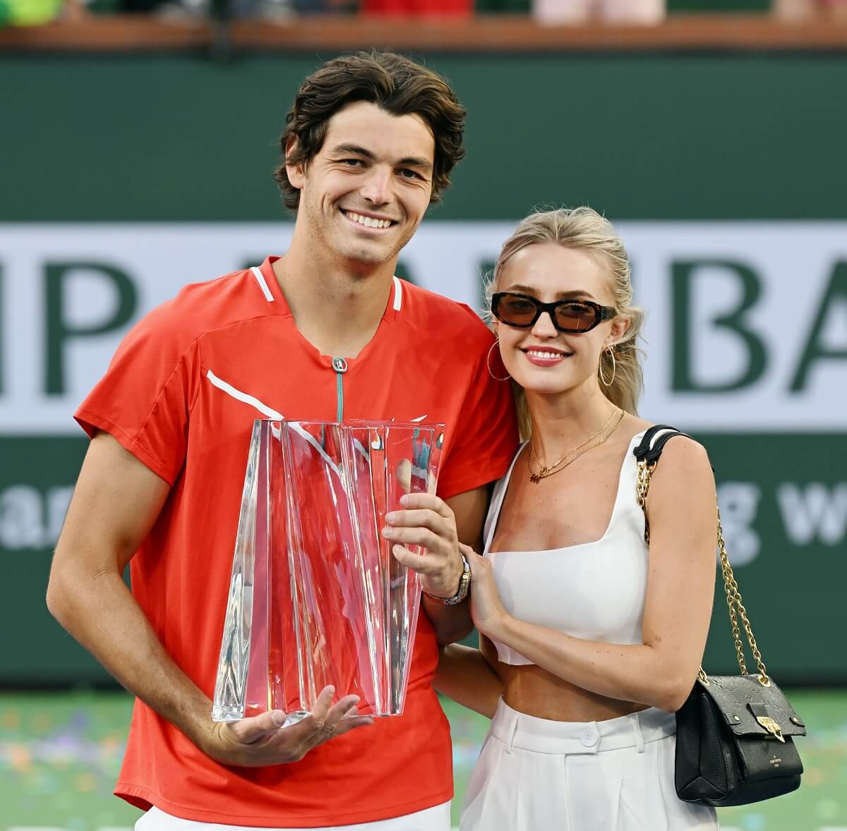 Taylor Fritz hold the championship trophy with girlfriend Morgan Riddle after winning a finals tennis match at the BNP Paribas Open