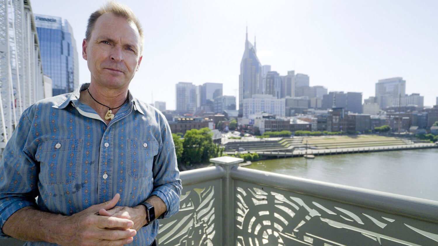 'The Amazing Race' host Phil Keoghan with a city in the background