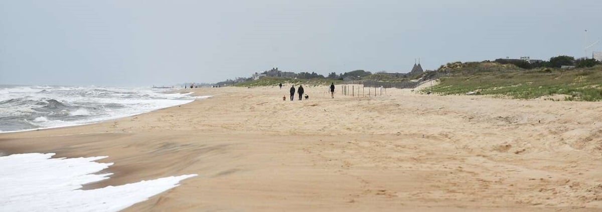 Citizens walk along the beach in Amagansett ahead of the summer season in 2020