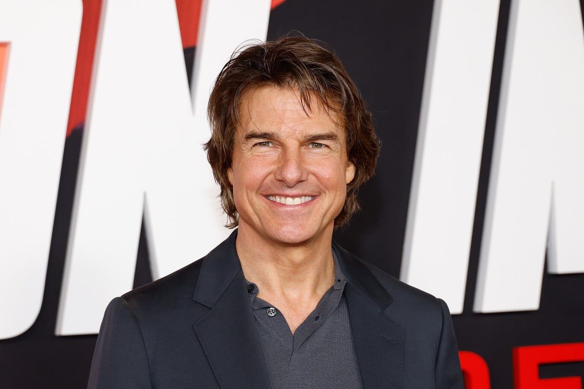 Tom Cruise posing in a suit at the 'Mission: Impossible - Dead Reckoning' premiere.