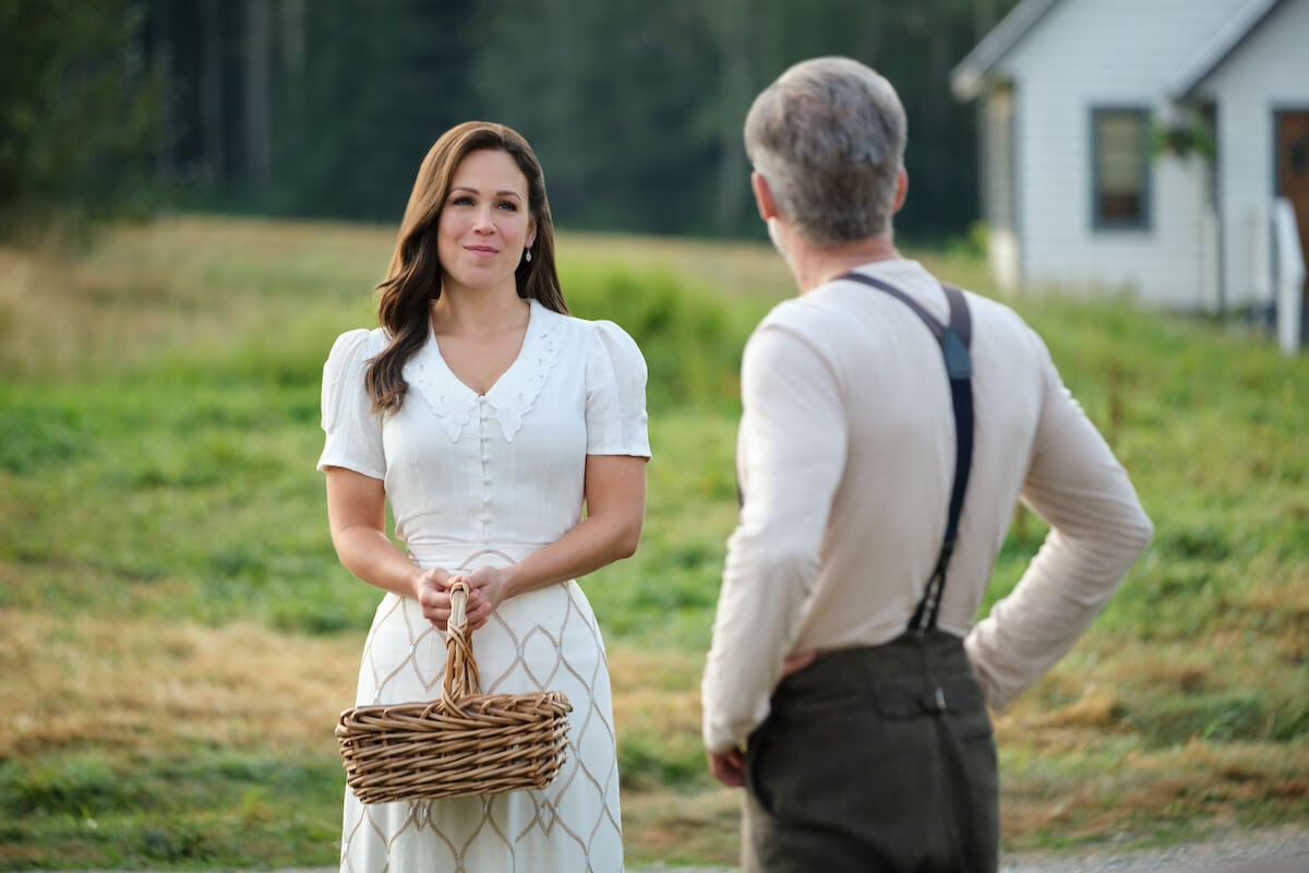 Elizabeth holding a basket and looking at Henry Gowen in 'When Calls the Heart' Season 10 Episode 5