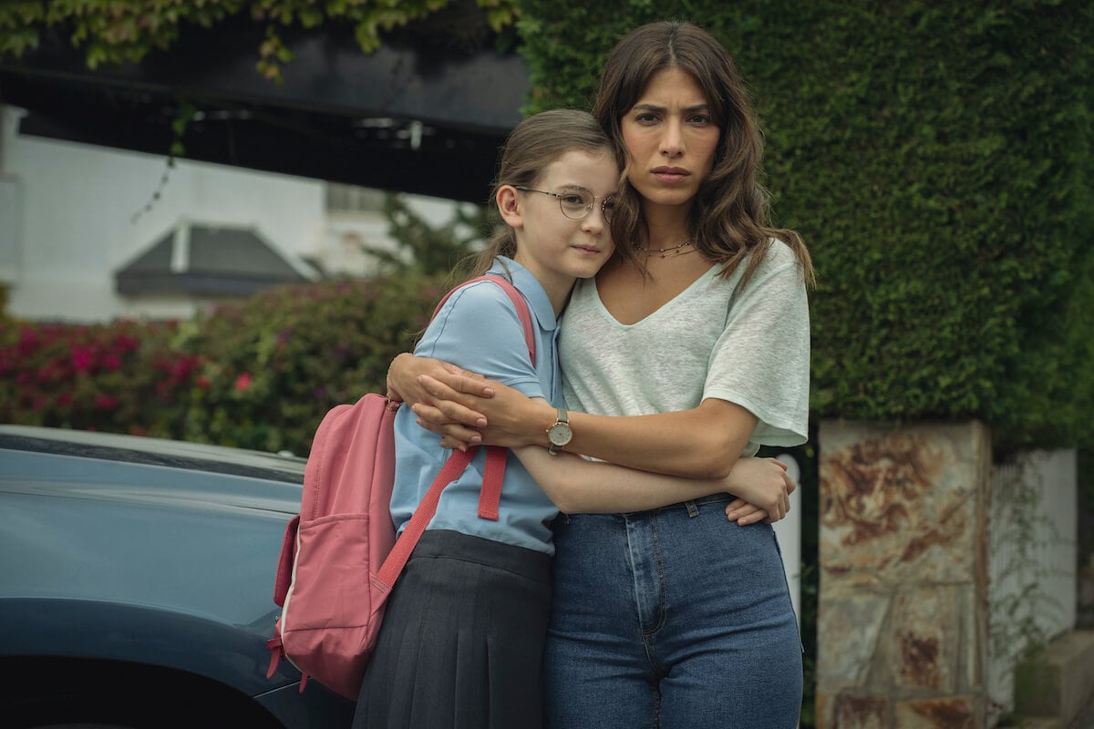 Erin with her arms around her daughter in the Netflix series 'Who Is Erin Carter?'