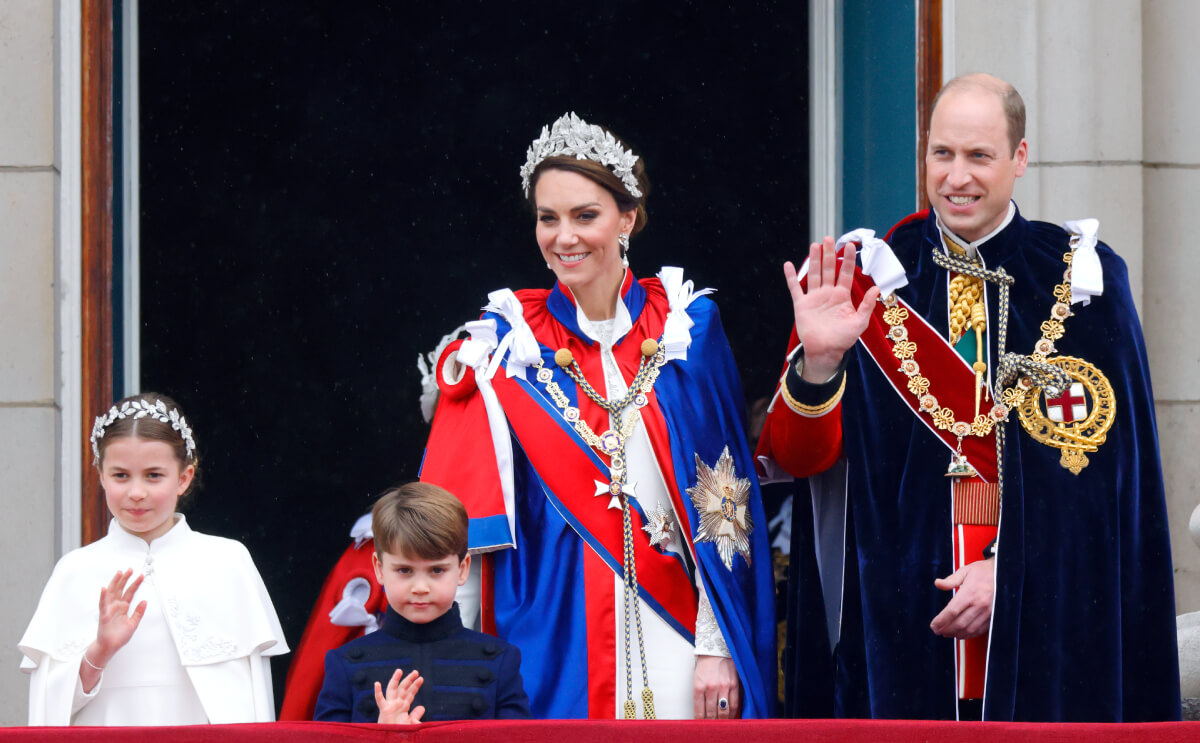 Princess Charlotte of Wales, Prince Louis of Wales, Catherine, Princess of Wales (wearing the Mantle of the Royal Victorian Order) and Prince William, Prince of Wales (wearing the Mantle of the Order of the Garter) watch an RAF flypast from the balcony of Buckingham Palace following the Coronation of King Charles III & Queen Camilla at Westminster Abbey on May 6, 2023 in London, England
