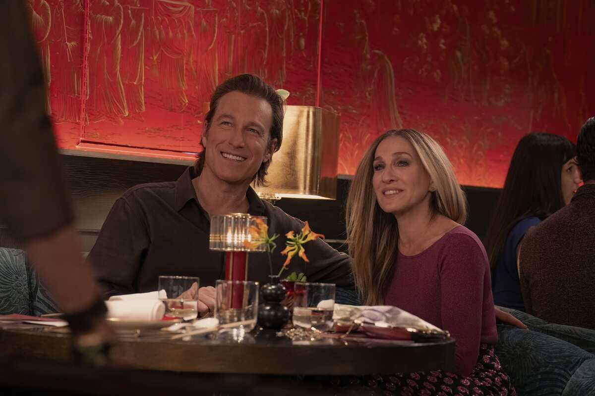 Aidan and Carrie sit together at a restaurant in season 2 of 'And Just Like That...'