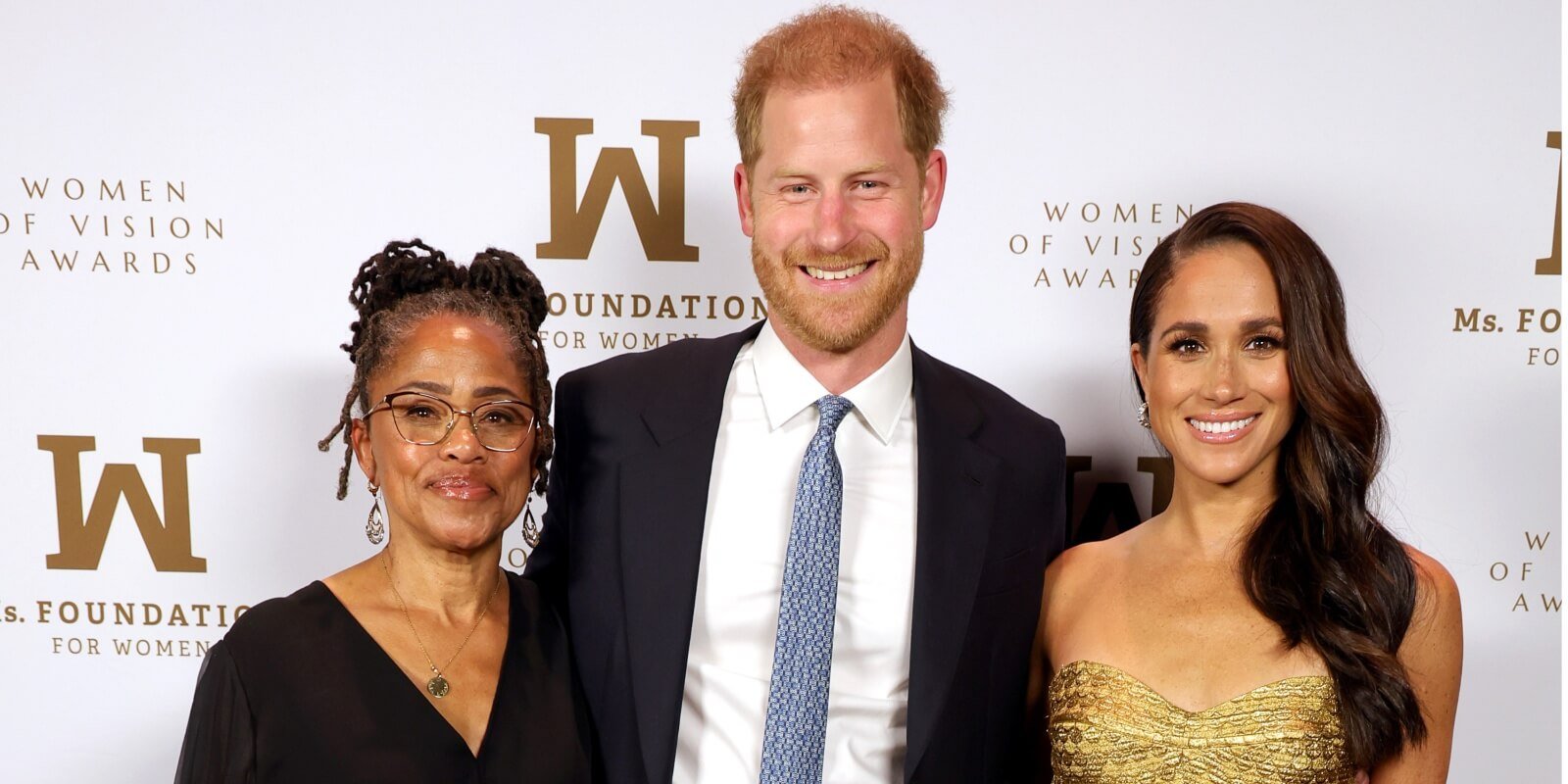 Doria Ragland, Prince Harry, and Meghan Markle pose together at the Women of Vision awards in May 2023.