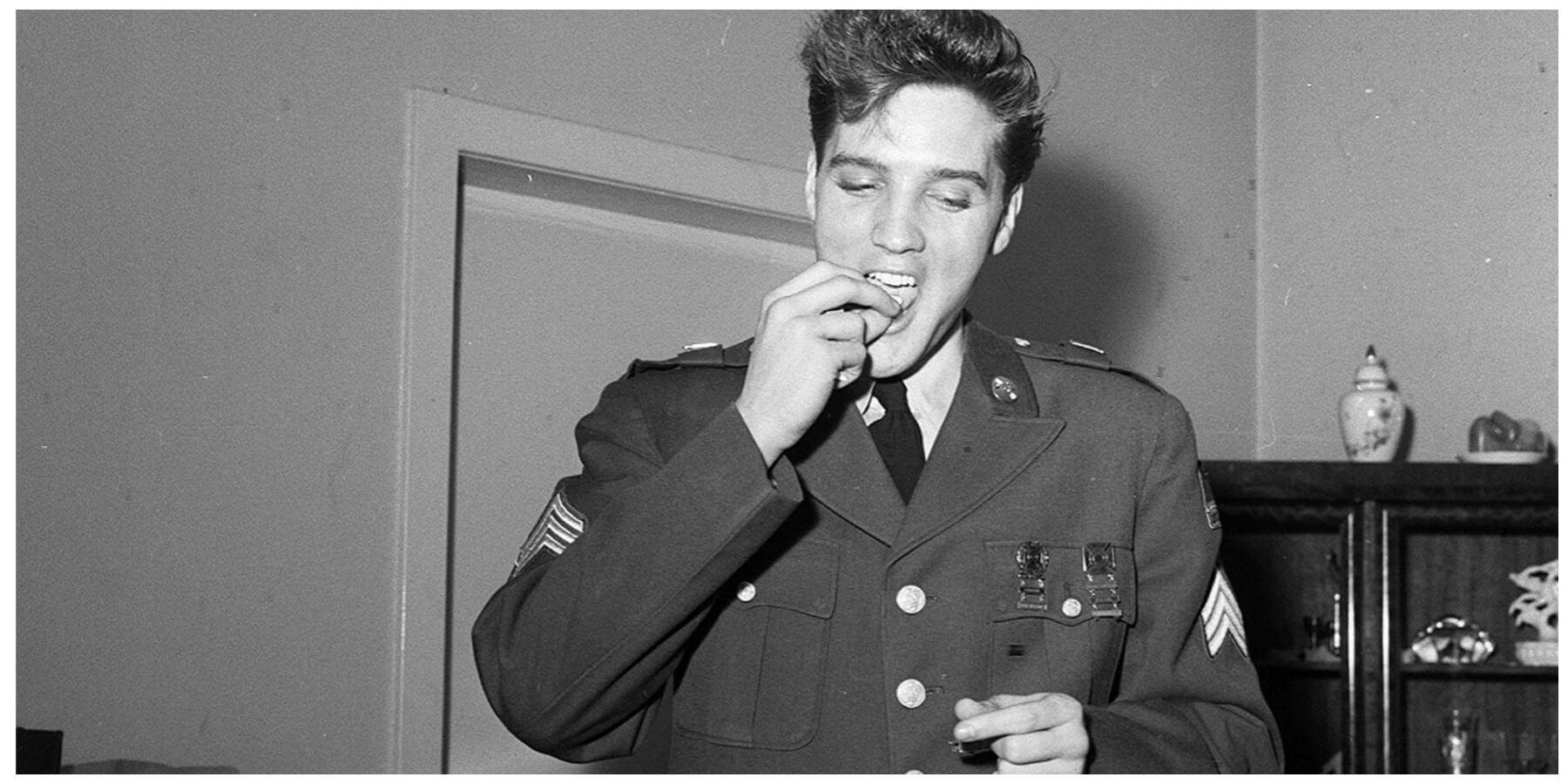 Elvis Presley eating while stationed in Germany as a soldier of the United States Army in March 1960.