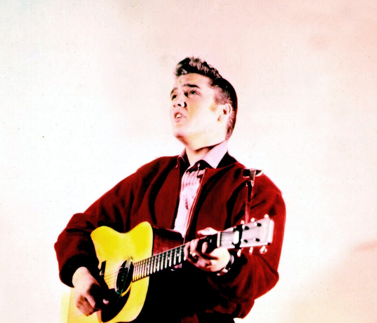 Elvis Presley playing a guitar