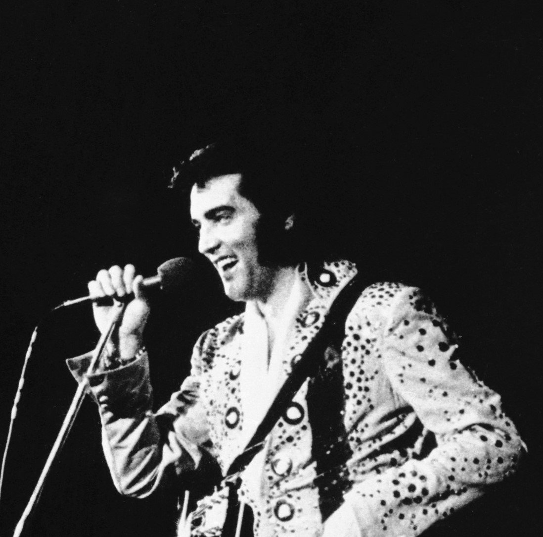 "Surrender" singer Elvis Presley with a microphone